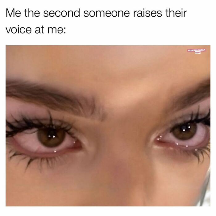 Close-up of a woman’s eyes with red, irritated lashes, capturing the chaos of navigating the world as a woman today.