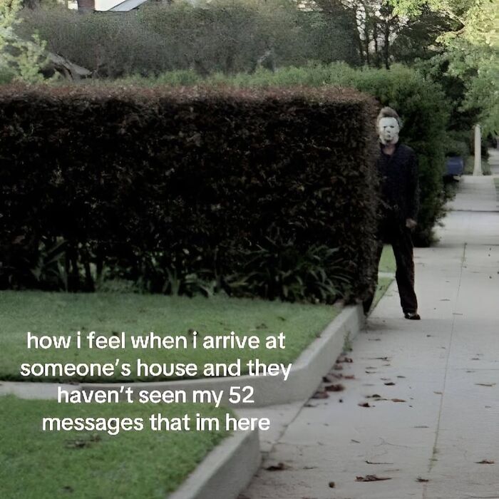 Man in a mask hiding behind a hedge illustrating relatable memes capturing the chaos of navigating the world as a woman today.