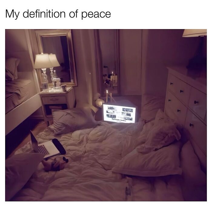 Cozy bedroom setup with laptop and pillows, illustrating relatable memes about navigating the world as a woman today.
