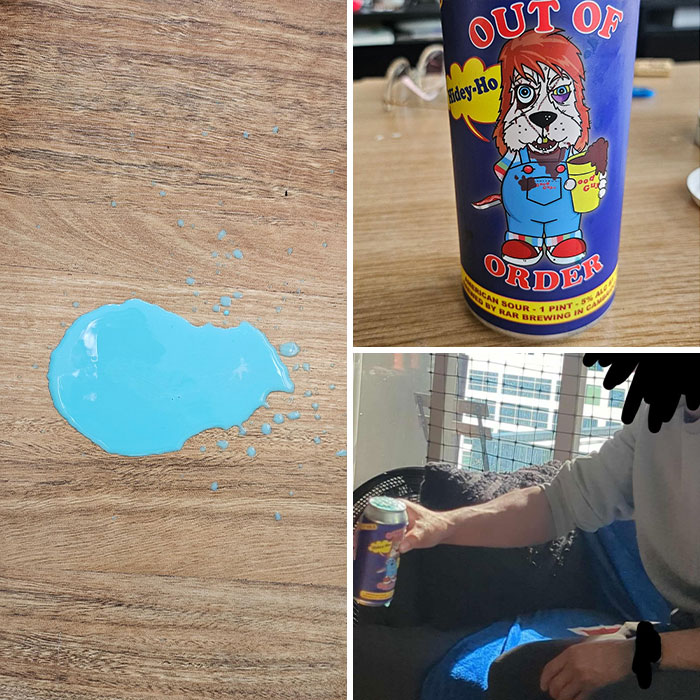 Spilled blue paint on wood table resembling a spilled drink beside a can with a cartoon dog labeled out of order.