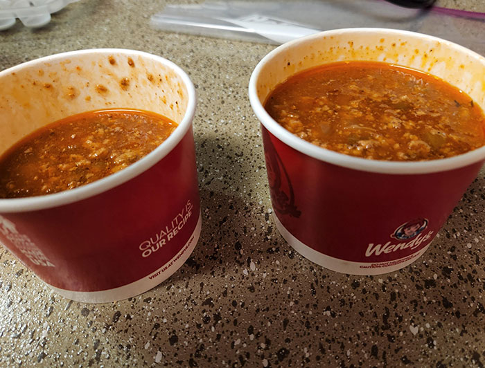 Two cups of Wendy’s chili on a kitchen counter highlighting chain restaurant employees’ ordering warnings.