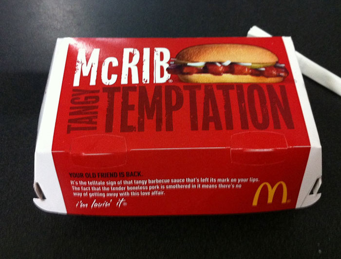 McDonald's McRib sandwich box on a table, highlighting chain restaurant employees' warnings about menu items.