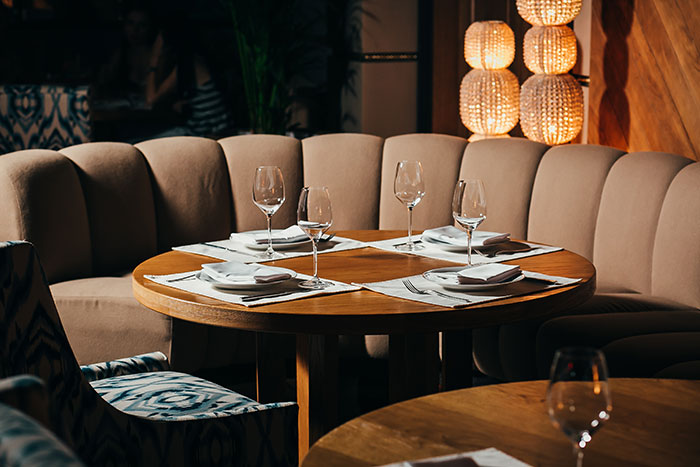 Elegant high-end restaurant table set for guests, reflecting rich people behavior in luxury dining settings.