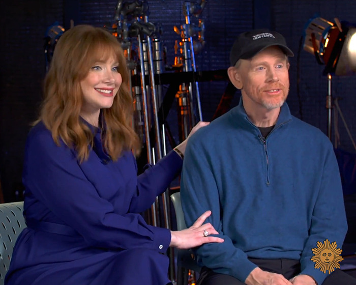 Bryce Dallas Howard and Ron Howard sitting together during an interview discussing her nepo baby childhood.