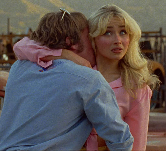 Couple in a tense embrace with woman showing discomfort, related to Sabrina Carpenter's album cover controversy on misogyny.