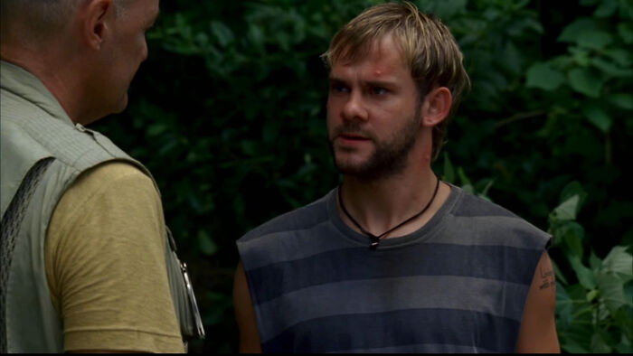 Two men in a forest scene from a TV show depicting tragic losses in TV show history.