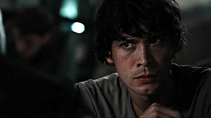 Close-up of a troubled young man in a dimly lit scene representing tragic losses in TV show history.