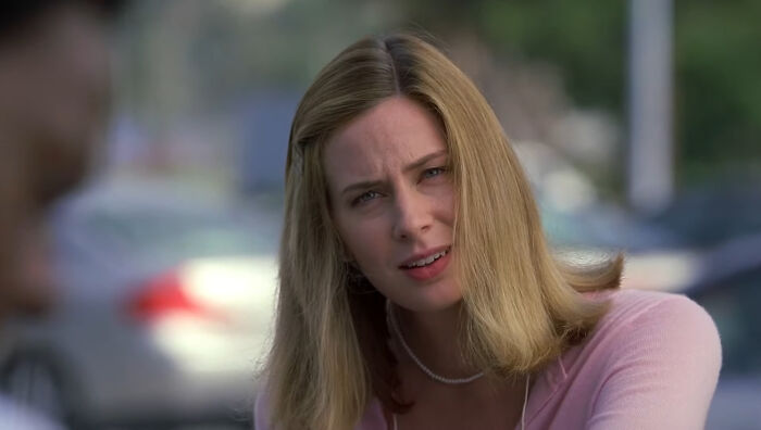 Young woman with blonde hair wearing a pink top, showing a concerned expression representing tragic losses in TV shows.