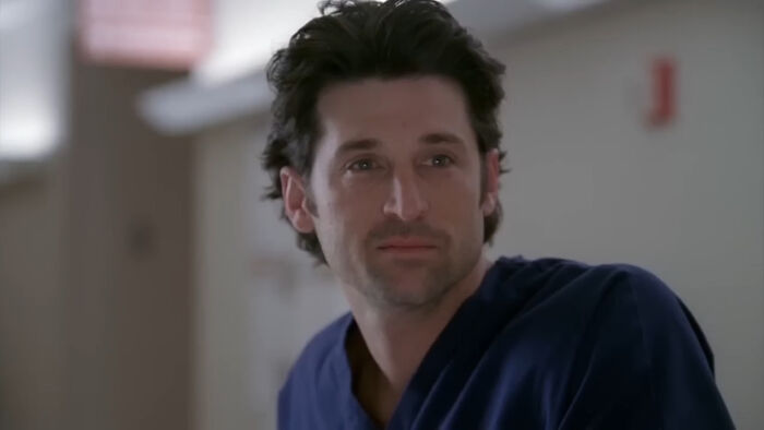 Man in blue scrubs with a serious expression, representing one of the most tragic losses in TV show history.