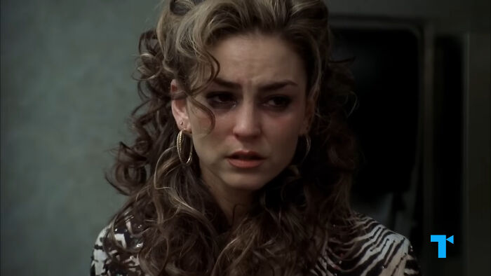 Woman with curly hair and hoop earrings looking distressed in a scene depicting tragic losses in TV shows.