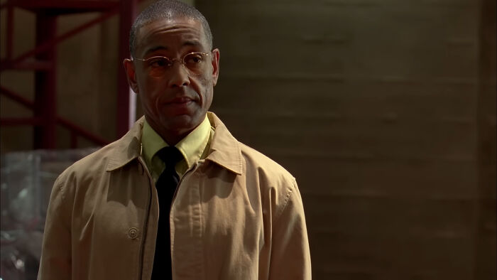 Man wearing glasses and beige jacket in a dimly lit setting, representing tragic losses in TV show history.