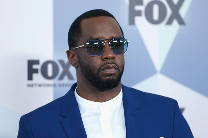 Diddy wearing sunglasses and blue suit at a FOX event, related to court sketch artist coverage of trial. Diddy wearing sunglasses and blue suit at a FOX event, related to court sketch artist coverage of trial.