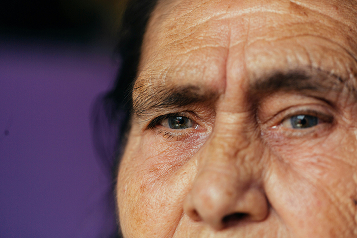 Close-up of an elderly person's wrinkled face and eyes conveying deep emotion, reflecting disturbing deathbed confessions.