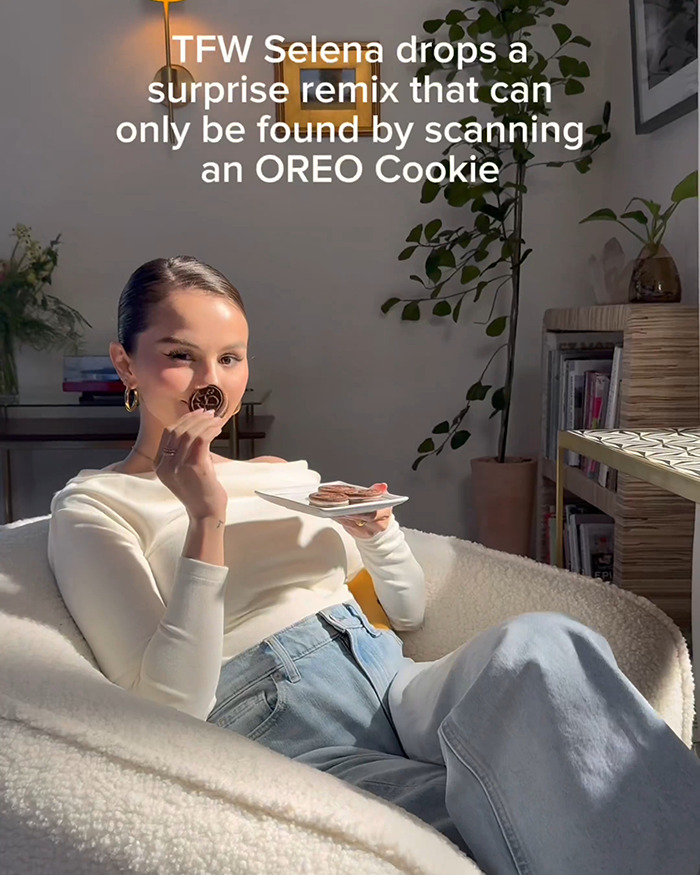 Woman relaxing in a chair eating Oreo cookies, highlighting Selena Gomez flavored Oreo and its surprise remix feature. Woman relaxing in a chair eating Oreo cookies, highlighting Selena Gomez flavored Oreo and its surprise remix feature.