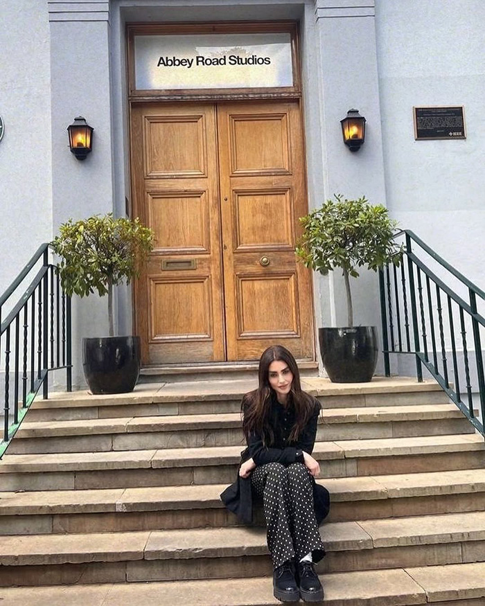 Sharon Osbourne's rarely-seen daughter sitting on steps outside Abbey Road Studios in a black outfit and polka dot pants