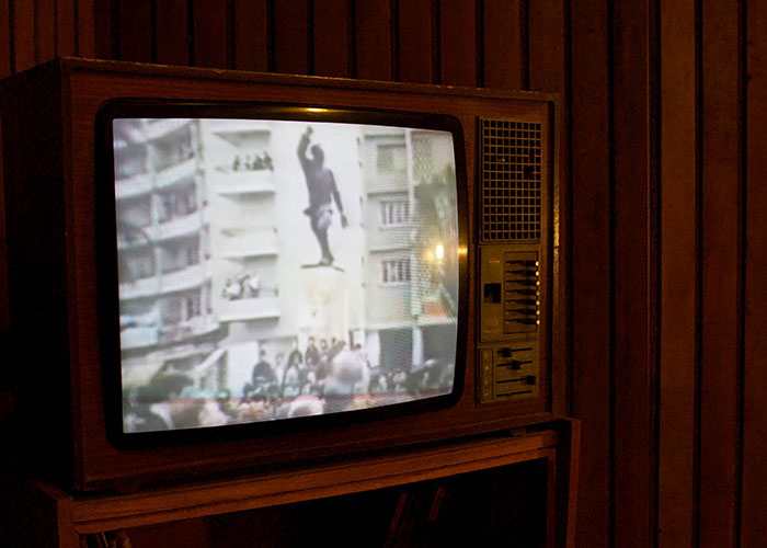 Vintage television showing a shocking live broadcast moment, highlighting memorable Gen X television experiences indoors.