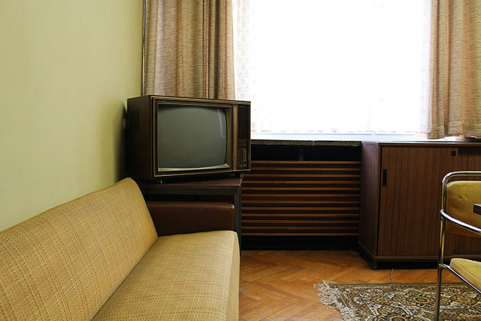 Vintage living room with old television set and retro furniture reflecting shocking moments on live television for Gen X viewers.