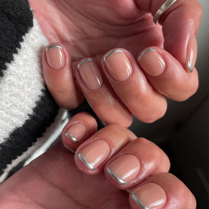 Short French tip nails with silver design on natural nails, showcasing stylish and trendy nail art for 2025. Short French tip nails with silver design on natural nails, showcasing stylish and trendy nail art for 2025.