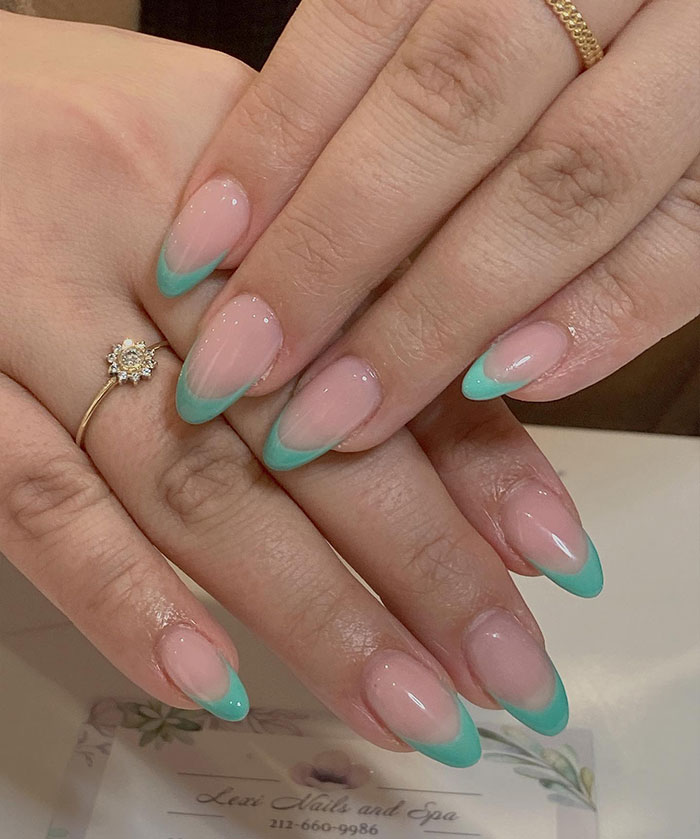 Short French tip nails with mint green design on natural nails, showcasing stylish nail art for 2025 trends.