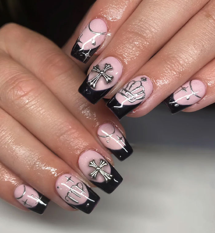 Short French tip nails with black tips and silver cross and crown designs, stylish and trendy nail art for 2025. Short French tip nails with black tips and silver cross and crown designs, stylish and trendy nail art for 2025.
