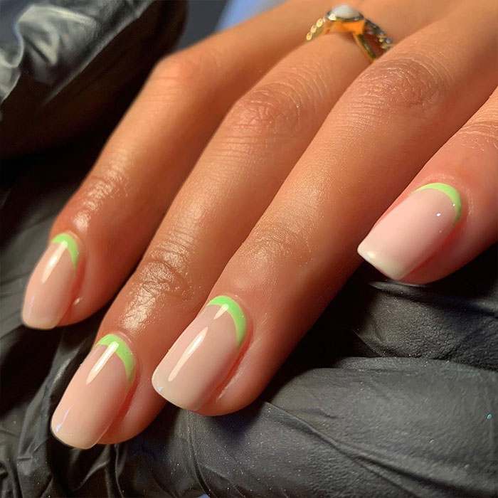 Short French tip nails with green design on natural nails, showcasing stylish nail art trends for 2025. Short French tip nails with green design on natural nails, showcasing stylish nail art trends for 2025.