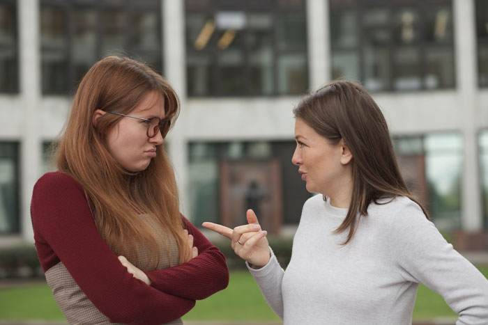 Two women arguing outside a building, depicting a greedy SIL confronting brother’s wife about house involvement. Two women arguing outside a building, depicting a greedy SIL confronting brother’s wife about house involvement.
