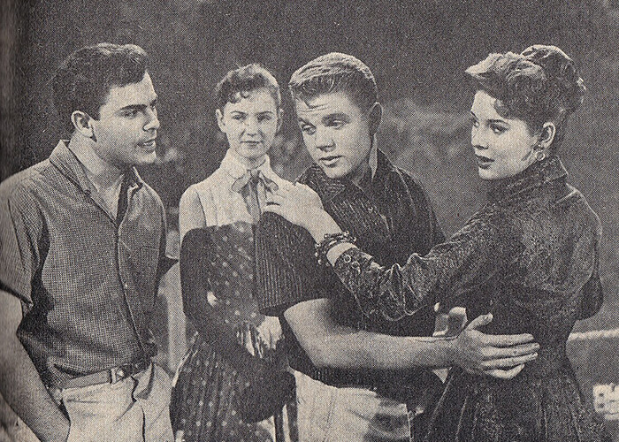 Black and white scene from an iconic sitcom legend show featuring four young actors in a dramatic moment together.