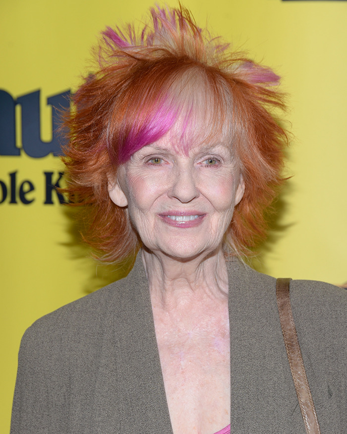 Iconic sitcom legend at 81 with bright orange and pink hair wearing a gray jacket during a rare public outing