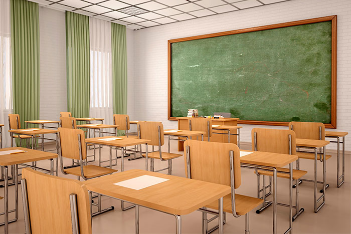 Empty classroom with wooden desks and chairs facing a large chalkboard illustrating kids lies that started silly and became real
