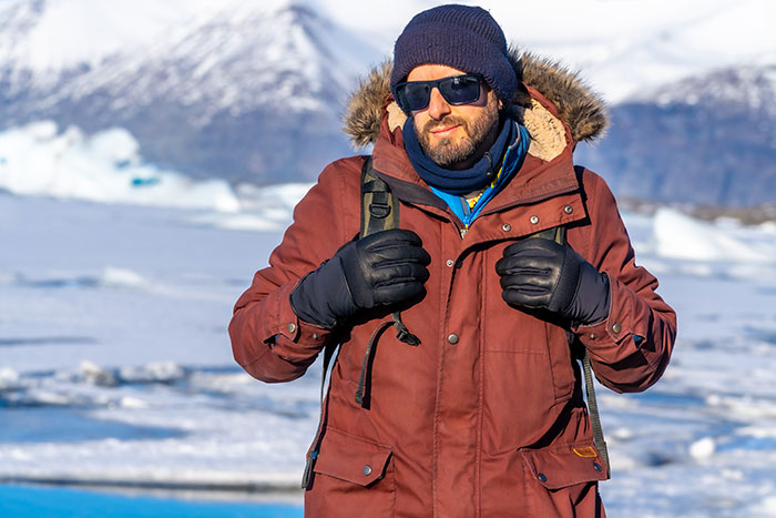 Man wearing winter coat and sunglasses in snowy landscape, illustrating kids' lies that started off silly and got too real.