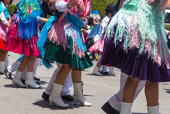 Children dancing in colorful traditional attire outdoors, illustrating kids’ lies that started off silly and got way too real.