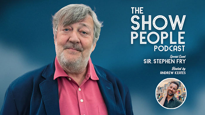 Stephen Fry on The Show People podcast, speaking about J.K. Rowling with a serious expression in a blue blazer.