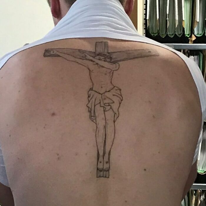 Back tattoo of a crucifixion scene with a person dabbing, showcasing bizarre choices people made while getting tattoos.