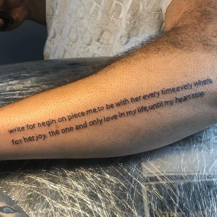 Tattoo on a forearm with long, misspelled text showing one of the bizarre choices people made while getting tattoos.