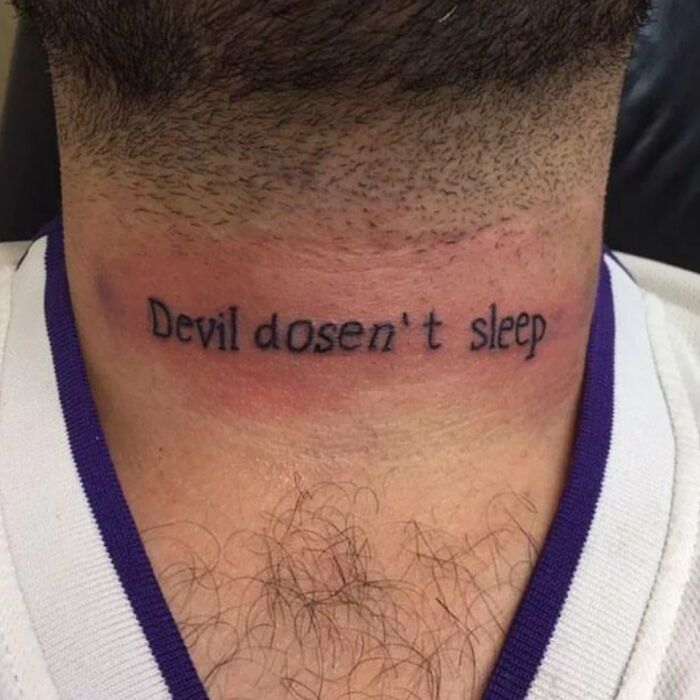 Neck tattoo with the misspelled phrase devil dosen't sleep showcasing bizarre choices people made while getting tattoos.