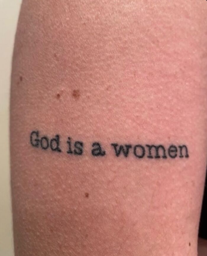 Tattoo on arm stating God is a women, showcasing bizarre choices people made while getting tattoos.