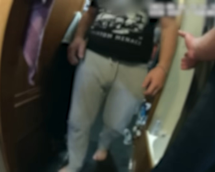 Teen mourner visibly devastated, chasing after hearse during funeral procession, expressing deep grief and sorrow.