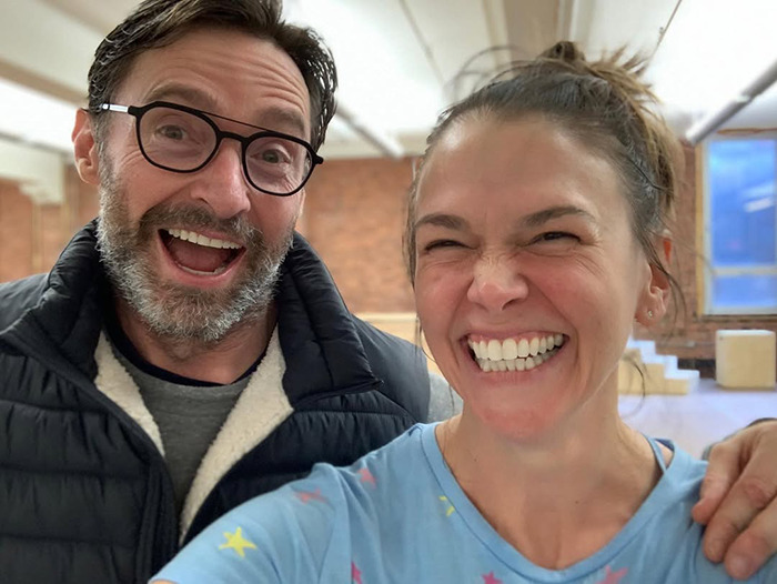 Hugh Jackman and his new girlfriend smiling together indoors, showing their close 17-year history connection.