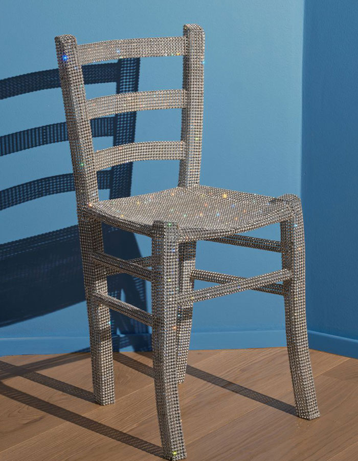 Crystal-covered Van Gogh chair displayed in an Italian gallery, sparkling with reflective crystals under bright lighting.