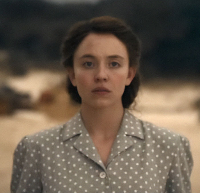 Sydney Sweeney with a dramatic makeover, wearing a polka dot blouse, portraying a survival thriller character in an outdoor setting.