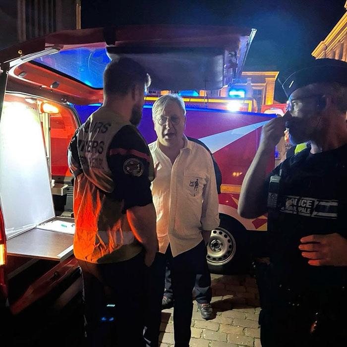 Emergency responders and police at night addressing violence against women incident at a popular music festival.