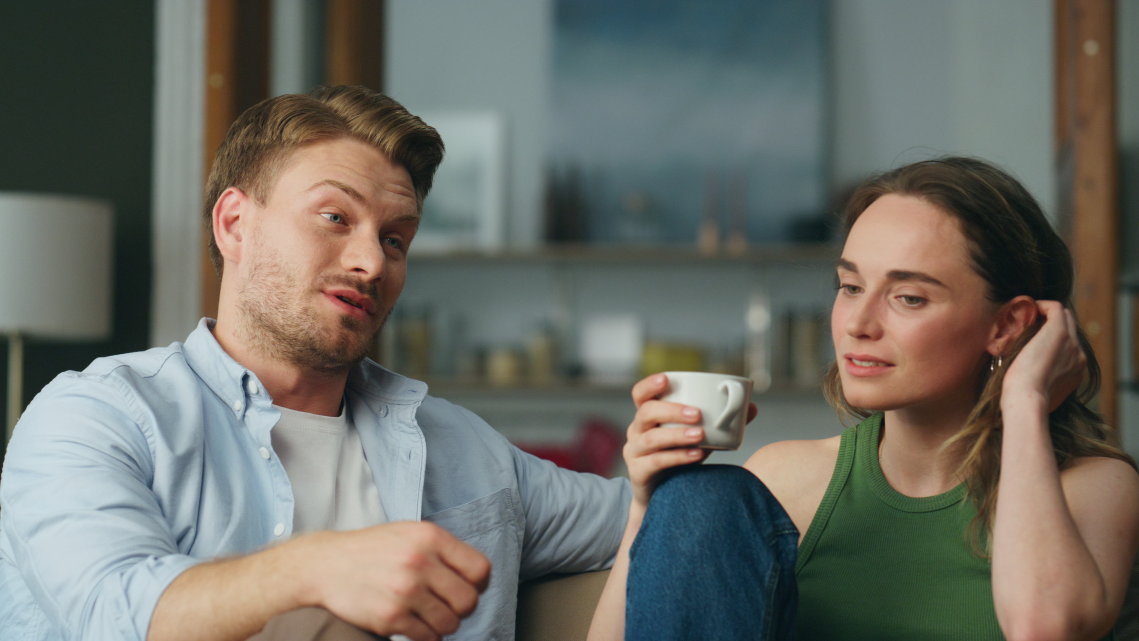 Couple having a serious conversation indoors, illustrating the stereotypical American wedding best man outfit issue.