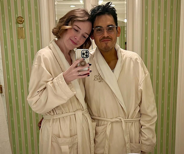 Couple wearing bathrobes taking a mirror selfie, related to Tanner Martin announcing his passing in a pre-recorded video. Couple wearing bathrobes taking a mirror selfie, related to Tanner Martin announcing his passing in a pre-recorded video.