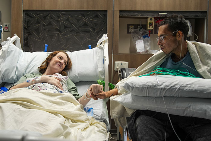 Tanner Martin in hospital bed holding hands with woman, reflecting on his passing days after his baby was born in pre-recorded video. Tanner Martin in hospital bed holding hands with woman, reflecting on his passing days after his baby was born in pre-recorded video.