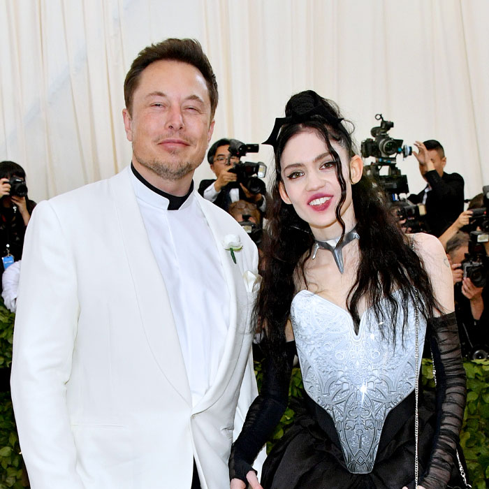 A portrait of the chaotic Musk family at an event, highlighting the Tau Techno Mechanicus theme in their fashion style.