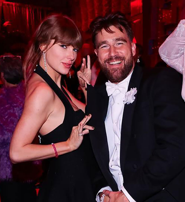 Taylor Swift at event with a man in tuxedo, spotlight on wealth display linked to Eras Tour criticism. Taylor Swift at event with a man in tuxedo, spotlight on wealth display linked to Eras Tour criticism.