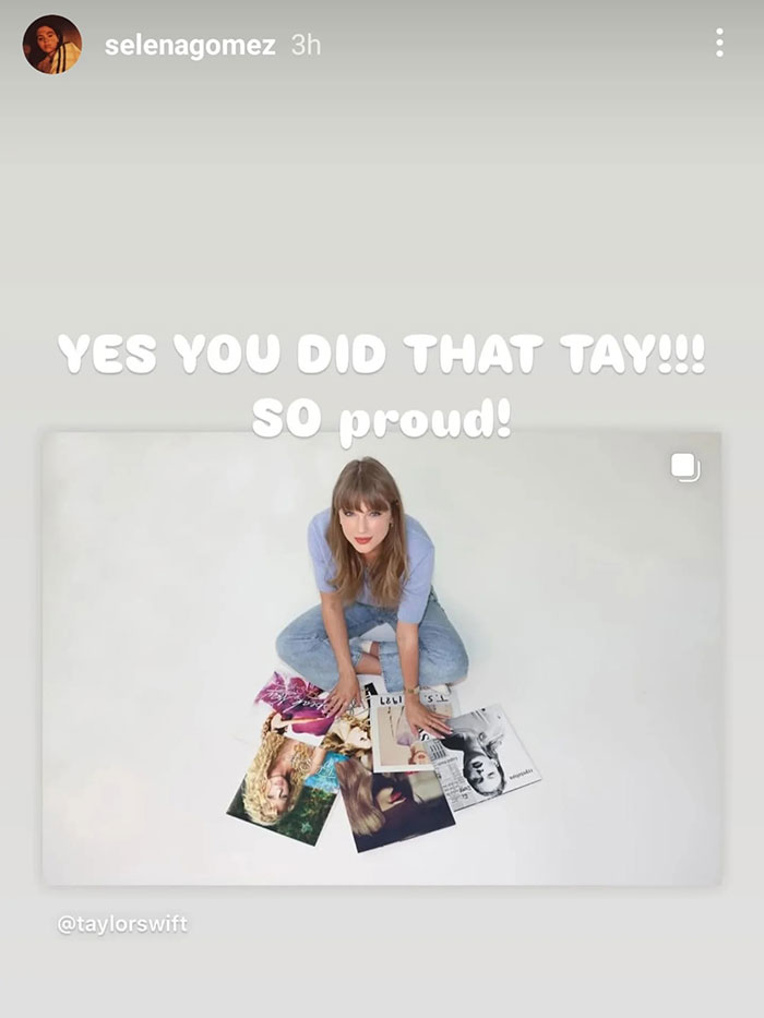 Taylor Swift sitting with album covers, receiving praise amid Eras Tour and wealth display controversy. Taylor Swift sitting with album covers, receiving praise amid Eras Tour and wealth display controversy.