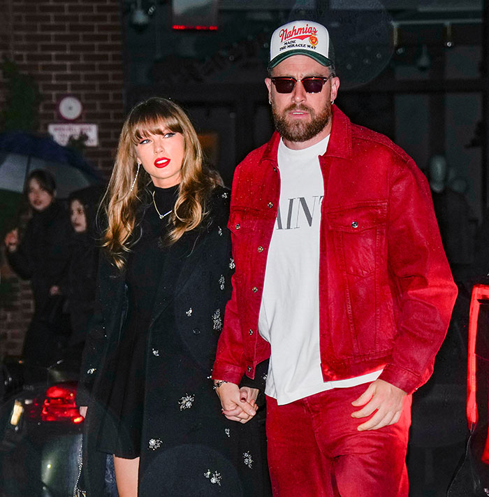 Taylor Swift and companion walking at night, showcasing wealth during Eras Tour outing in fashionable attire. Taylor Swift and companion walking at night, showcasing wealth during Eras Tour outing in fashionable attire.