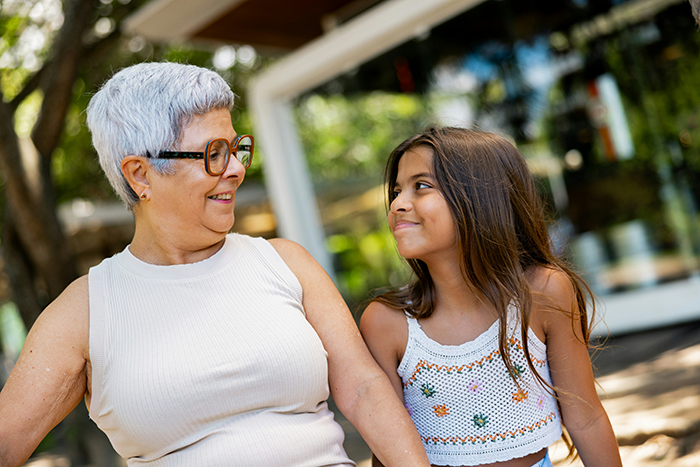 Teen girl looking uncertain while spending time with an older woman outside, reflecting struggle babysit step siblings. Teen girl looking uncertain while spending time with an older woman outside, reflecting struggle babysit step siblings.