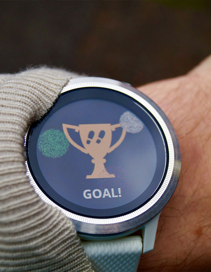 Smartwatch on wrist showing a trophy and goal message, highlighting the Japanese walking trend for better daily activity. Smartwatch on wrist showing a trophy and goal message, highlighting the Japanese walking trend for better daily activity.